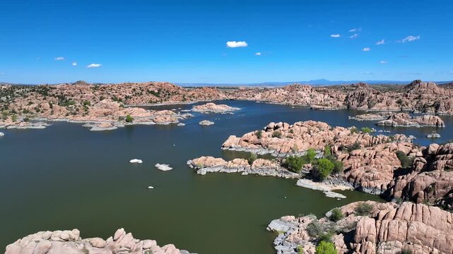 Aerial view of Watson Lake with its distinctive rock formations nestled amid the serene waters under a clear blue sky, Watson Lake, Arizona, United States.