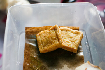 close up fried tofu on plastic box