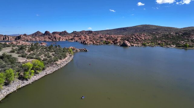 Aerial view of Watson Lake's granite dells contrasting with the clear blue sky, creating a beautiful landscape, Watson Lake, Prescott, Arizona, United States.