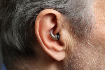 Obraz premium Close-Up of a Hearing Aid in a Man's Ear