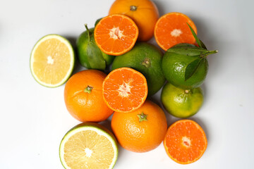 Oranges and limes on white background