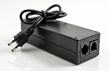 Black power supply unit with EU plug on cord isolated on white background. Power adapter with ethernet ports. Compact power supply for networking equipment. Modern technology device.