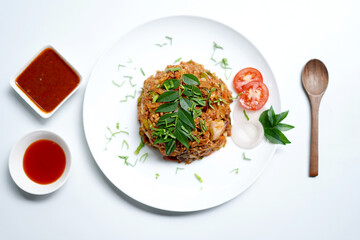 Tasty Sri Lankan Kottu Roti with Curry Flavor. curry dish and tomato sauce, spoon