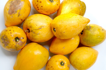 Yellow egg fruit close up on white background.