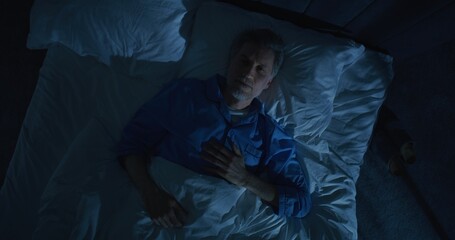 Gray Haired Mature Man Lies in Bed Unable Sleep, Lost in Thoughts About Aging and Solitude. Concept...