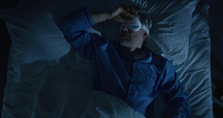 Man in Bed, Illuminated by Cold Moonlight, Suffers From Insomnia. European Man, Exhausted and...