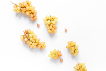 Many fresh green grape clusters isolated on white background.