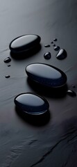  smooth black stones and water droplets on dark slate surface zen spa concept
