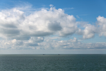 Fototapeta premium tranquil seascape with fishing boats and clouds