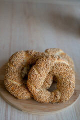 Hot homemade Turkish simit in the kitchen. Bagels with sesame seeds. Pastries.