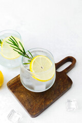 Lemon cocktail with rosemary on wooden board