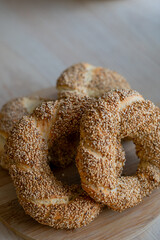 Hot homemade Turkish simit in the kitchen. Bagels with sesame seeds. Pastries.