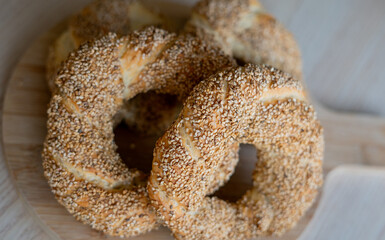 Hot homemade Turkish simit in the kitchen. Bagels with sesame seeds. Pastries.