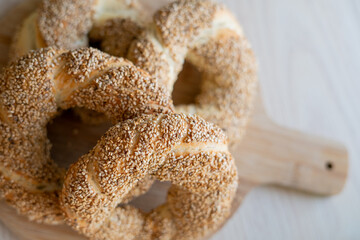 Hot homemade Turkish simit in the kitchen. Bagels with sesame seeds. Pastries.