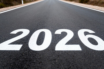 A road with the year two thousand and twenty six painted in white on the asphalt surface of the road
