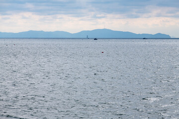 tranquil seascape with fishing boats and clouds