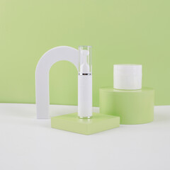 white cosmetics bottle and jar with green background