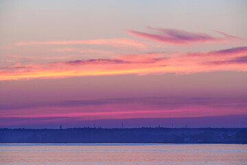 Calm sea at sunset with navigation buoys and distant coastline