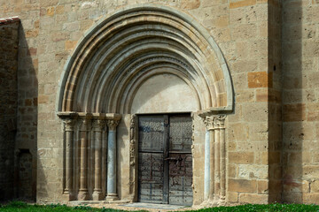 Fototapeta premium Carved porch entrance of Romanesque church in Mailhat, Puy de Dome, Auvergne Rhone Alpes, France