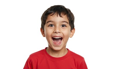 A young boy with dark hair is smiling widely showing his teeth in front of a white background