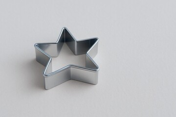 small metallic cookie cutter shaped as star concept of pastry decoration food advertising