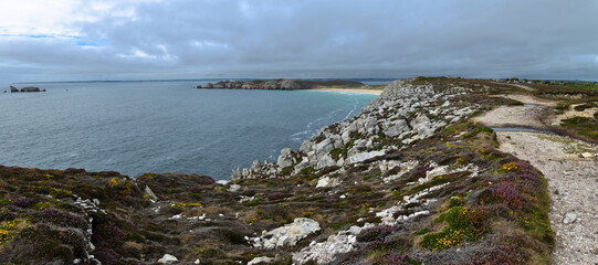 Vue panoramique sur une plage au sable blanc et crevasses de la presqu'ile de Crozon en Bretagne