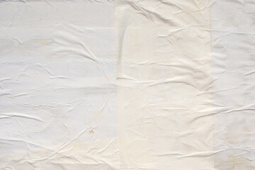 white crumpled and creased glued wrinkled paper poster texture background