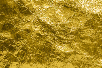 Luxury shiny metallic golden foil crumpled texture background