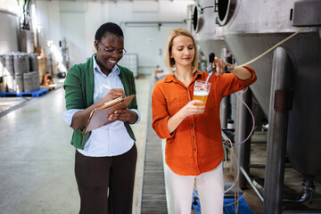 Brewery women performing quality control during beer production
