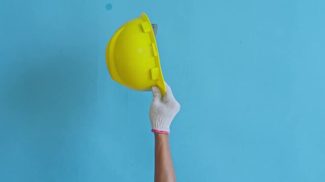 Worker's hands raised showing various tools isolated on blue background