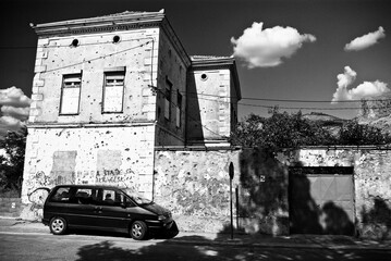 Monochrome artistic view of historic stone architecture with vintage automobile in rural Serbian setting