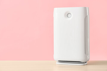 Modern air purifier on pink background