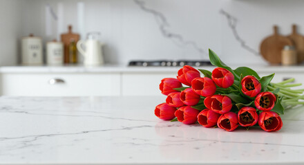 Bouquet of red tulips on marble kitchen counter celebrating International Women's Day.copy space
