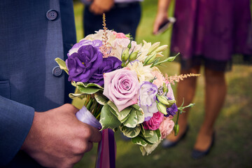 Close-up of the bride's wedding bouquet in purple tones