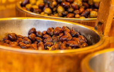 Assorted mediterranean olives in rustic wooden bowls