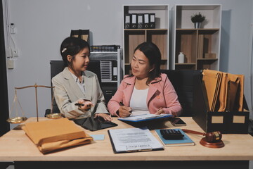 Consultation and conference of professional businesswoman and Male lawyers working and discussion having at law firm in office. Concepts of law, Judge gavel with scales of justice