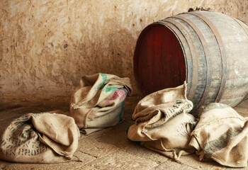 Burlap sacks and wooden barrel storing products