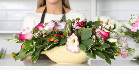 Florist presenting beautiful mixed floral arrangement