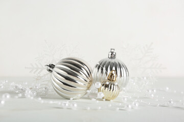 Christmas baubles with garland and snowflakes on white background