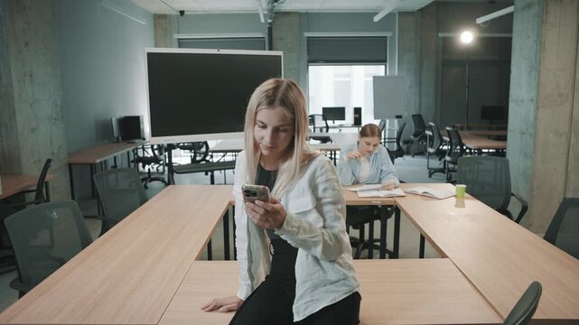 Business team collaborates with documents in modern office environment while using smartphones