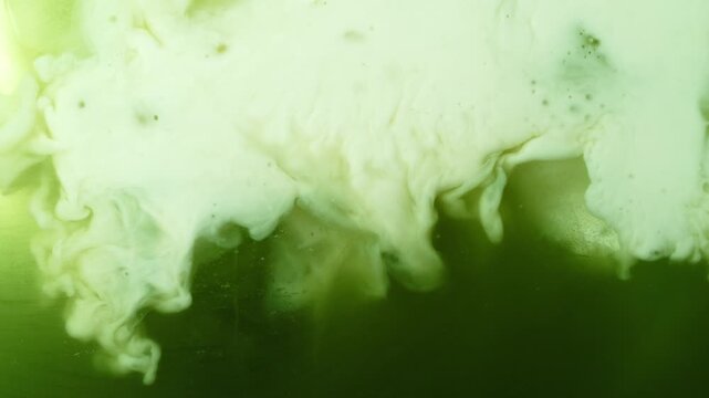 Super Slow Motion Detail Shot of Pouring Cream into Matcha Latte at 1000fps.