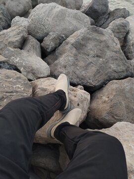 man sitting on rock