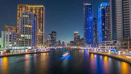 Obraz premium Dubai Marina towers and canal in Dubai day to night timelapse