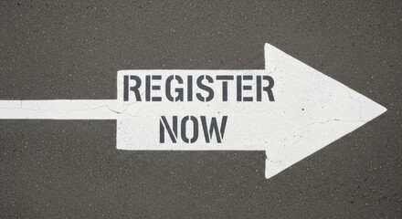 White arrow painted on asphalt with the words register now pointing to the right
