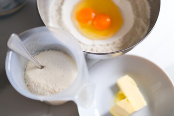 Baking ingredients: eggs, flour, butter, yeast in preparation for homemade recipe