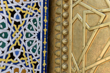 Brass door with Arabic calligraphy and Moroccan zellij mosaic tilework. Royal Palace, Fez, Morocco
