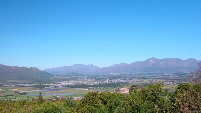 Elevated vista over Boland farm lands and vineyards toward Franschhoek mountains