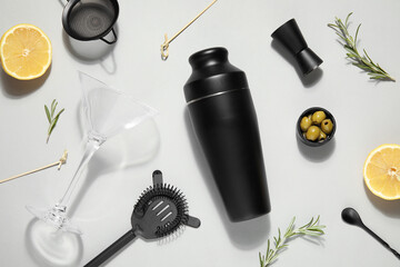 Modern bartender kit and cocktail ingredients on white background