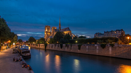Cathedral Notre Dame de Paris day to night timelapse after sunset in Paris, France.