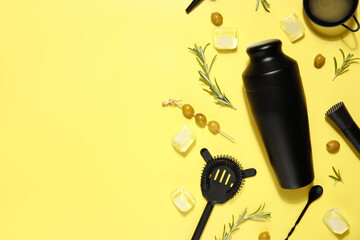 Modern bartender kit and cocktail ingredients on yellow background
